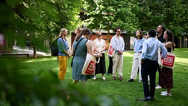 People gathering in the grass at Kings Cross, London.